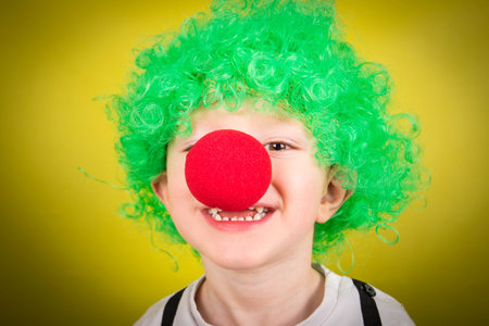 little boy wearing clown object for carnivalの写真素材
