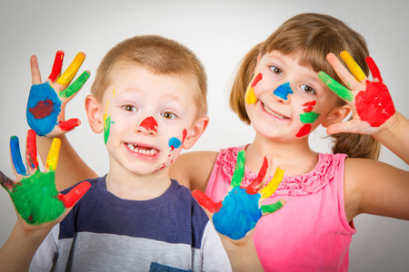 little smiling children with hand painted in colorful paintsの写真素材