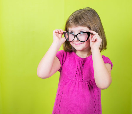 smiling little girl with glassesの写真素材