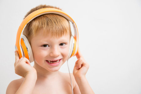 young boy listen music with headphoneの写真素材