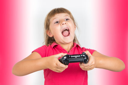 young girl with virtual reality headset and joystick playing vr gamesの写真素材