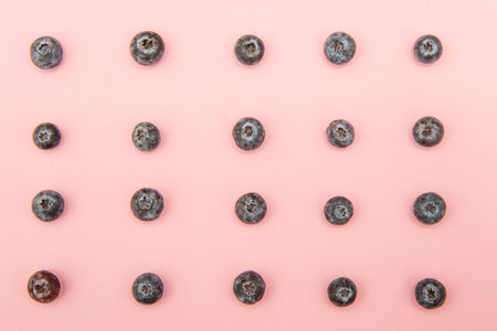 blueberries on a pastel pink background