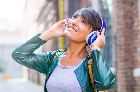 beautiful woman are listening music with headphoneの写真素材