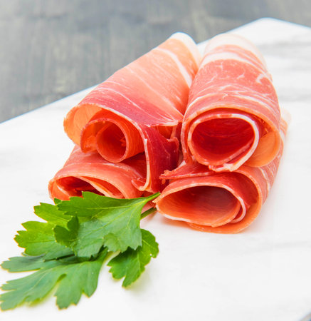 marble dish with raw ham slicesの写真素材