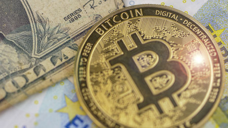 Euro banknotes, american dollar and bitcoin coins, financial concept of global economic crisis.の写真素材