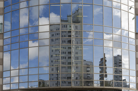 reflected in the windows of the round building