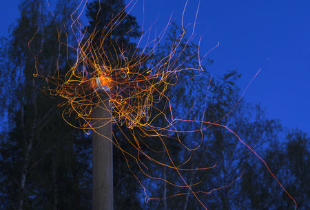 sparks fly from the chimney in the night sky