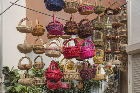 colorful baskets hanging from the ceiling in the storeの写真素材