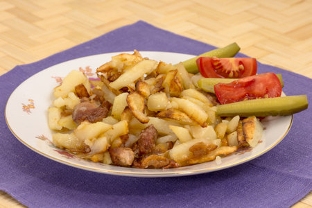 Fried potatoes with pork cracklings on a plate