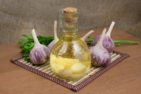 oil infused with garlic, ingredients and spices on a wooden table topの写真素材