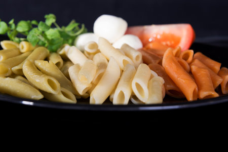 Italian pasta color - green, white and red - Penne lisceの写真素材