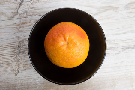grapefruit or pomelo is a black bowlの写真素材