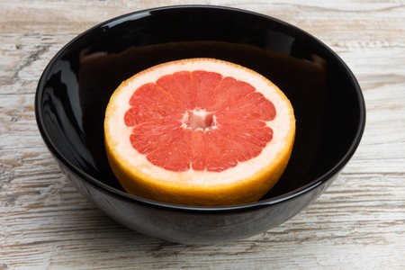 grapefruit or pomelo is a black bowlの写真素材