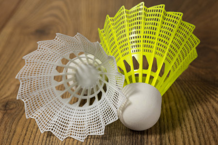 shuttlecocks for badminton white and yellow on the wooden floorの写真素材