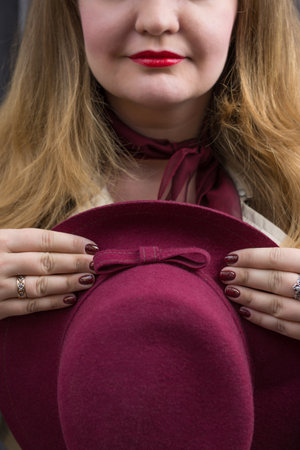 young blond woman and a purple hatの写真素材