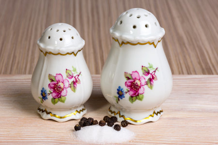 old-fashioned salt and pepper shakers on the tableの写真素材