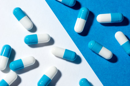 medicine capsule on a white and blue backgroundの写真素材