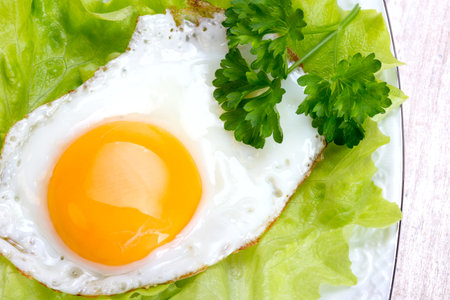 Breakfast - scrambled eggs, lettuce, parsleyの写真素材
