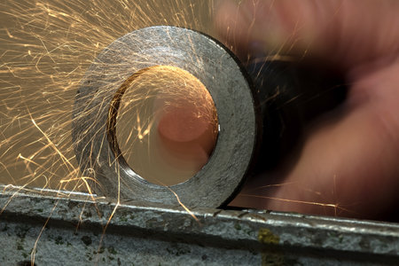 grinding of steel by electric hand abrasive toolsの写真素材