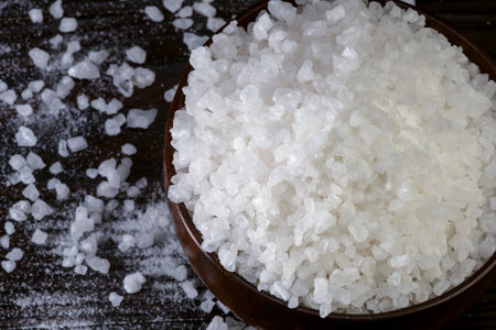 coarse crystalline sea salt in a wooden bowlの写真素材