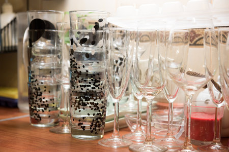 Clean glassful and wine glasses on the tableの写真素材