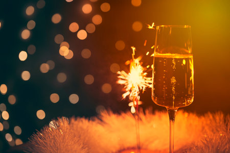 champagne glass with sparkler, festive background, vintage colorsの写真素材