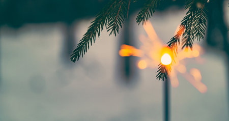 winter background with sparkler, the concept of Christmas and new year