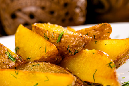 Fried potato wedges on white plate. Close upの写真素材