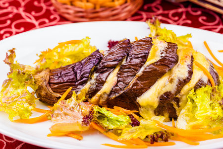 Eggplant baked with cheese on white plate. Close-upの写真素材