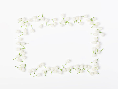 Floral frame made of lily of the valley isolated on white background. Top view. Flat lay.の写真素材