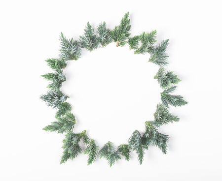 Round frame made of juniper branches isolated on white background. Top view with copy space. Flat lay. Christmas or New year composition.の写真素材