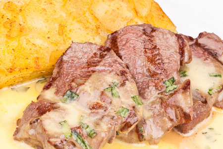 Beef tenderloin with potato pie on white plate. Close upの写真素材