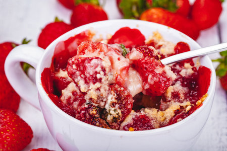 Strawberry crumble in cup on wooden rustic table. Close upの写真素材