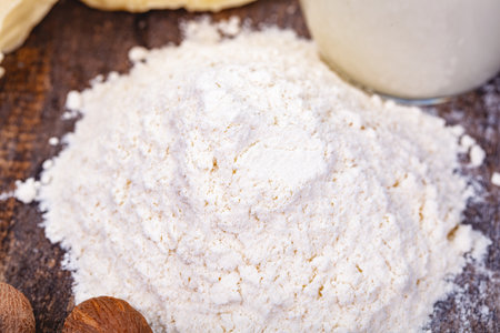 Pile of wheat flour on wooden table. Close upの写真素材