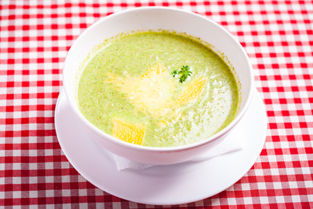 Broccoli cream soup with cheese in white bowl. Close upの写真素材