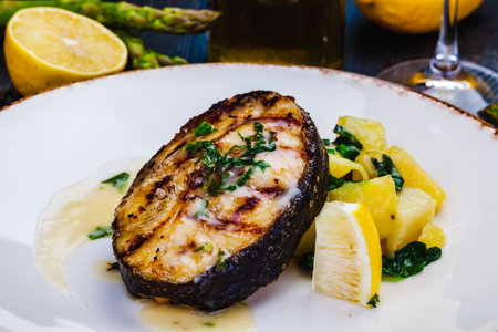 Grilled salmon steak with potato and spinach on white plate