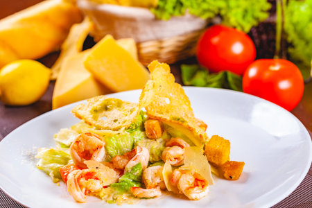 Caesar salad with shrimps on white plateの写真素材