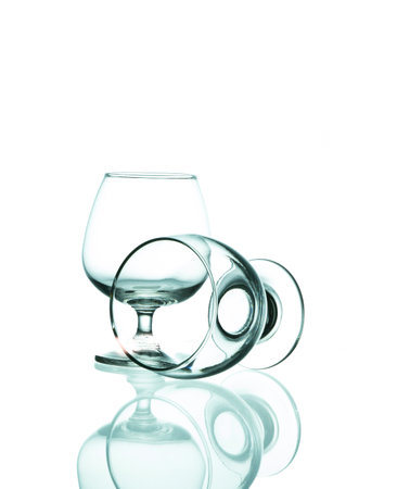 Closeup shot of empty wine glasses on white isolated.の写真素材