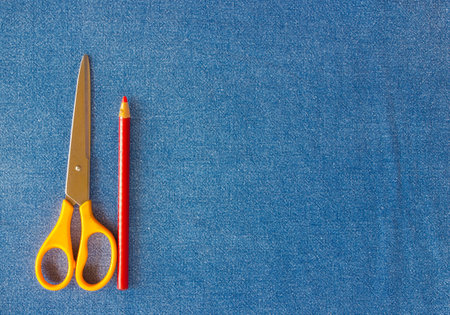 Scisors and pencil on local jean,closeup shot.の写真素材