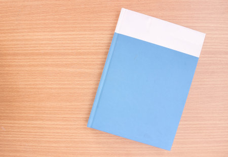 Topview shot of hardcover memo book on wooden board.の写真素材