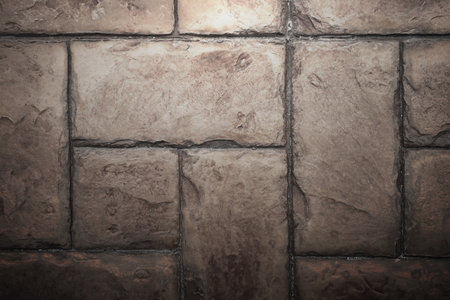 Stone Tile Cement Brick Wall Background Texture with Lighting from above.の写真素材