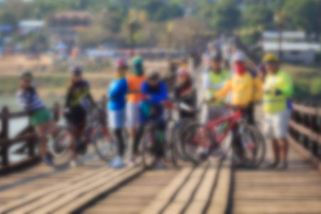Blurred image of Cyclists are on the wooden bridge.の写真素材