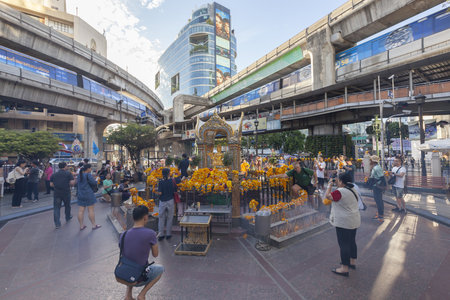 Bangkok, Thailand, August 22, 2015: People worship Brahma Statue ,one of the greatest God in Hinduism Religion near the Erawan Hotel ,Ratchaprasong Intersection after bombed explosion.のeditorial素材
