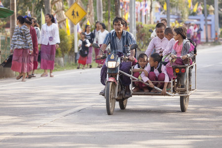 Sangkhlaburi, Thailand - January 23, 2015: Group of Students are in the Tri Motorcycle back from school at Sangkhlaburi.のeditorial素材