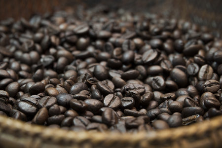 Roasted coffee beans in the wicker basket.の写真素材