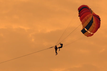 Silhouette of Parasailing in the sky.の写真素材