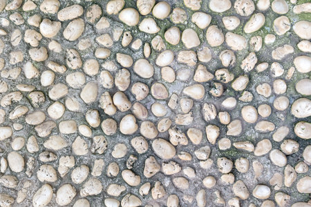 Naturally polished old white rock pebbles pattern texture.