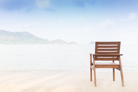 Wooden chair on the beach in the morning. - Selective focus on a chair.の写真素材