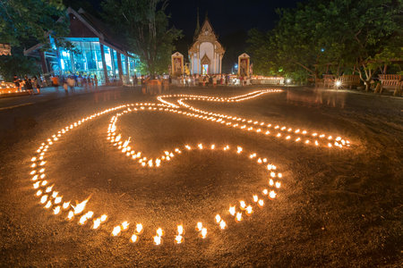 Candle light was arranged in a number 9. It mean a number of the King of Thailand for Thai religious day "Phansa" took place at Wat tha khanun in Kanchanaburi, Thailand.の写真素材