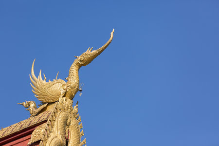 Architecture on the temple Thai gable roof against blue sky background.
